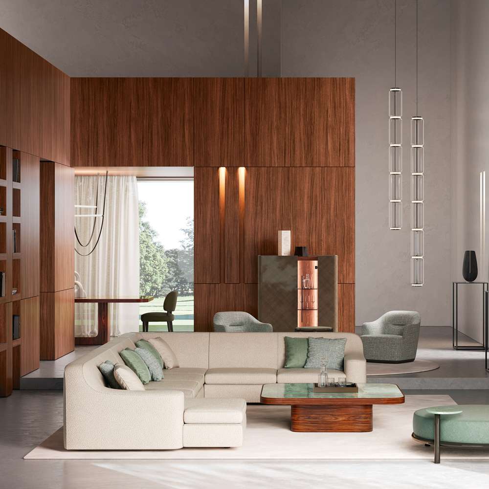Cream corner sofa with green cushions and a walnut coffee table before walnut-panelled walls and glass pendants