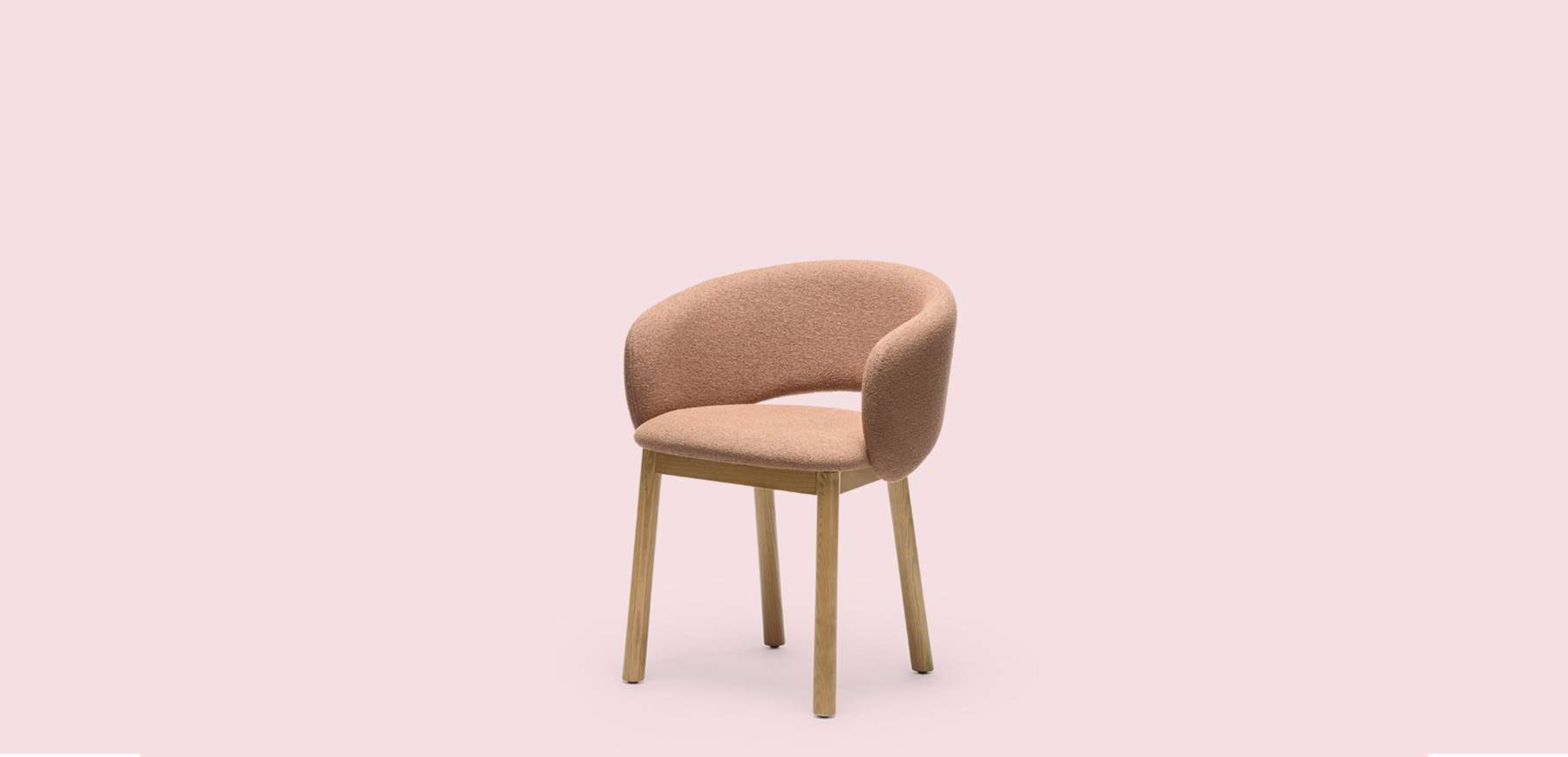 Pink upholstered dining chair with a wrap-around back