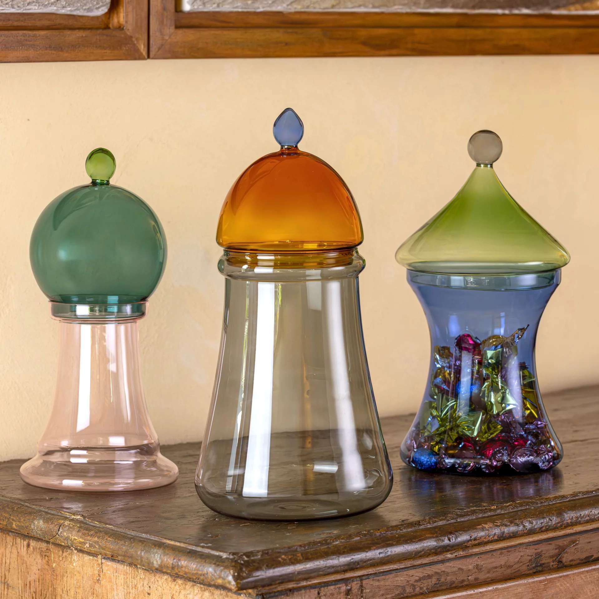 Glass jars with green and amber domed lids