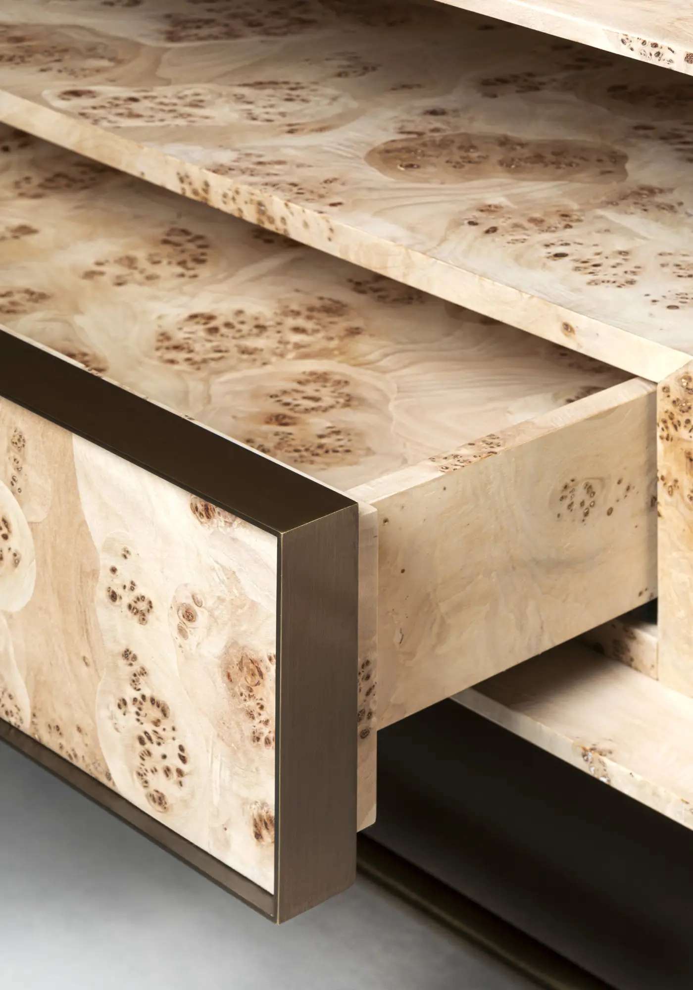 Burl wood drawer with a bronze edge, pulled open