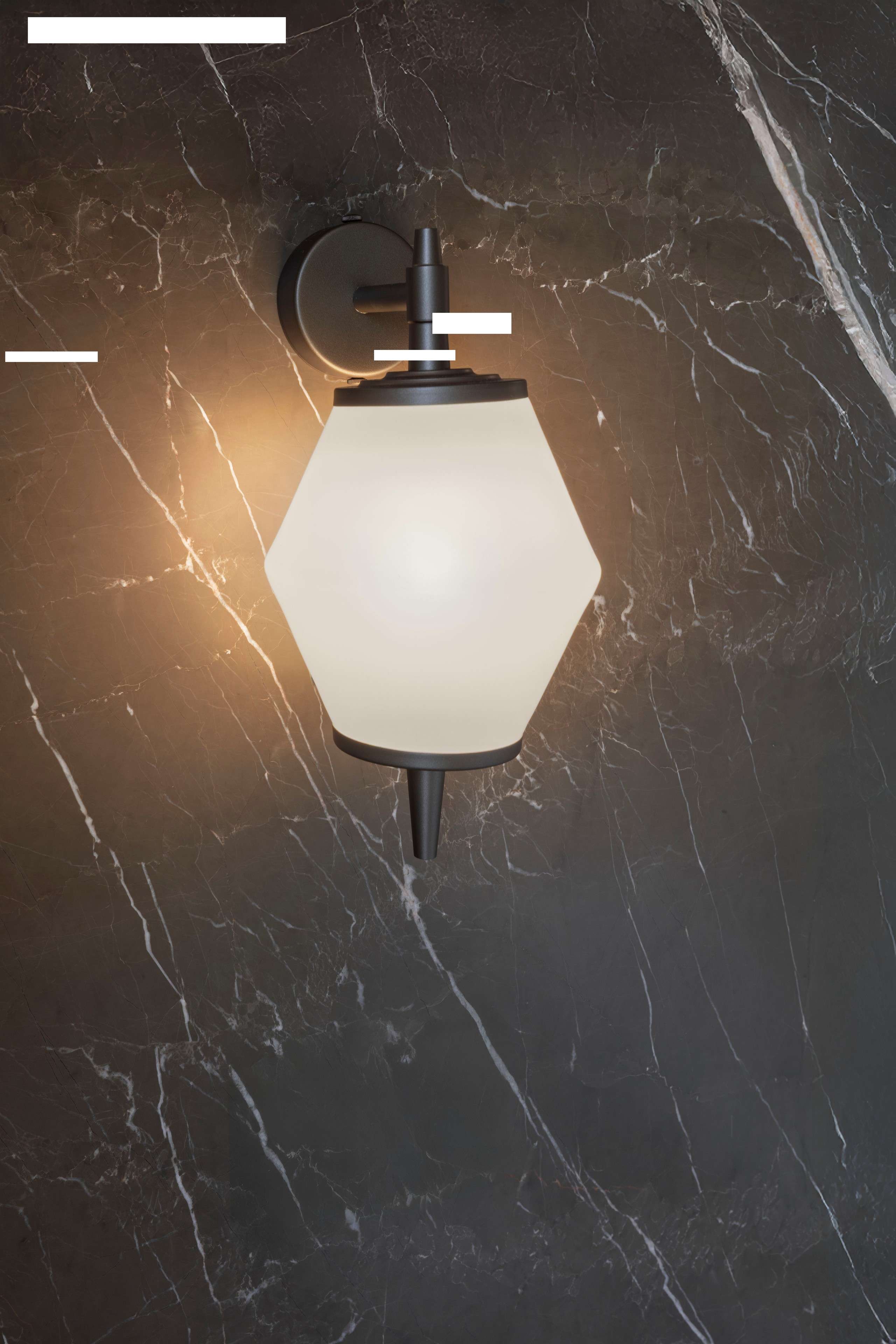 Opal glass wall lamp on dark veined marble