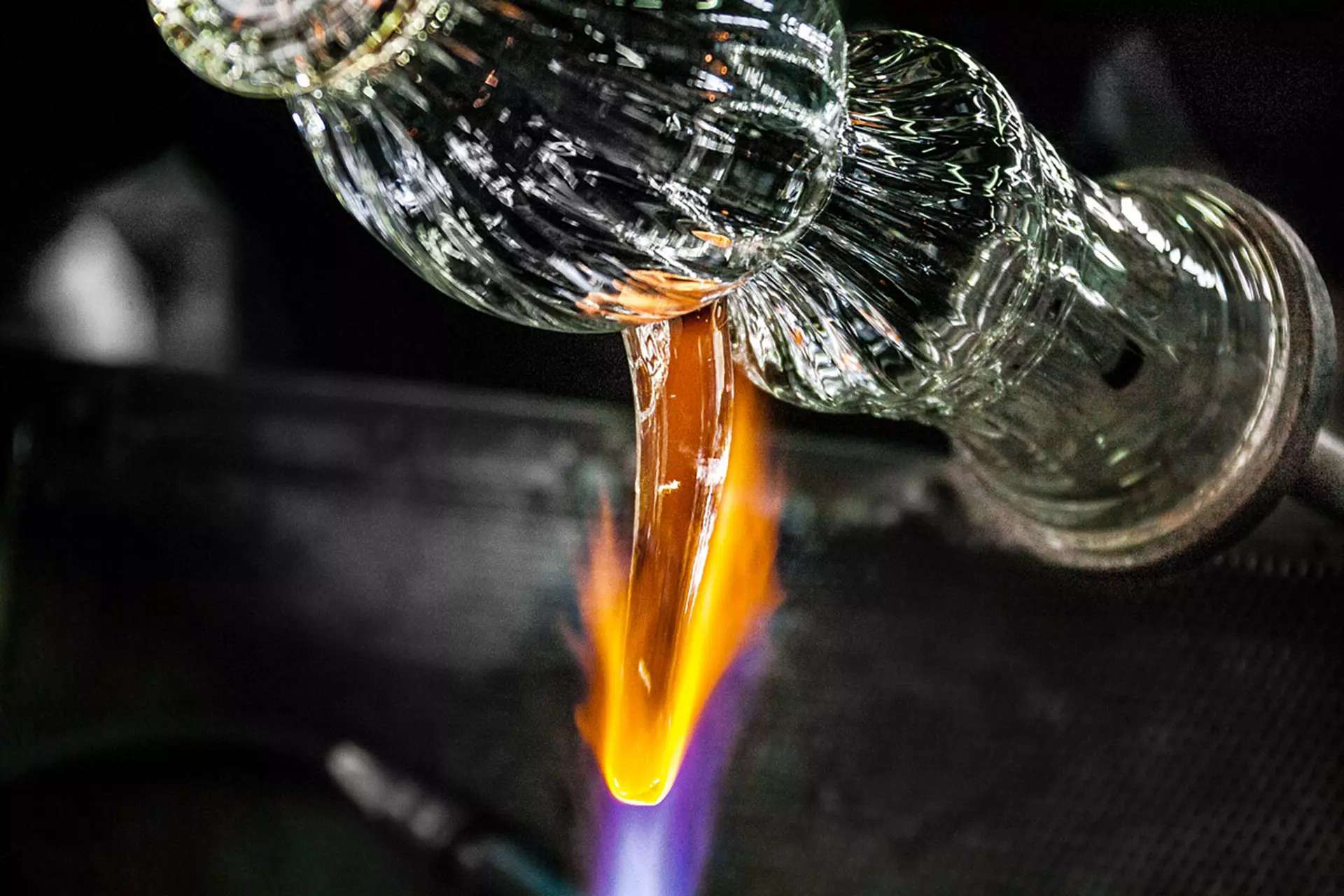 Molten glass shaped over a flame