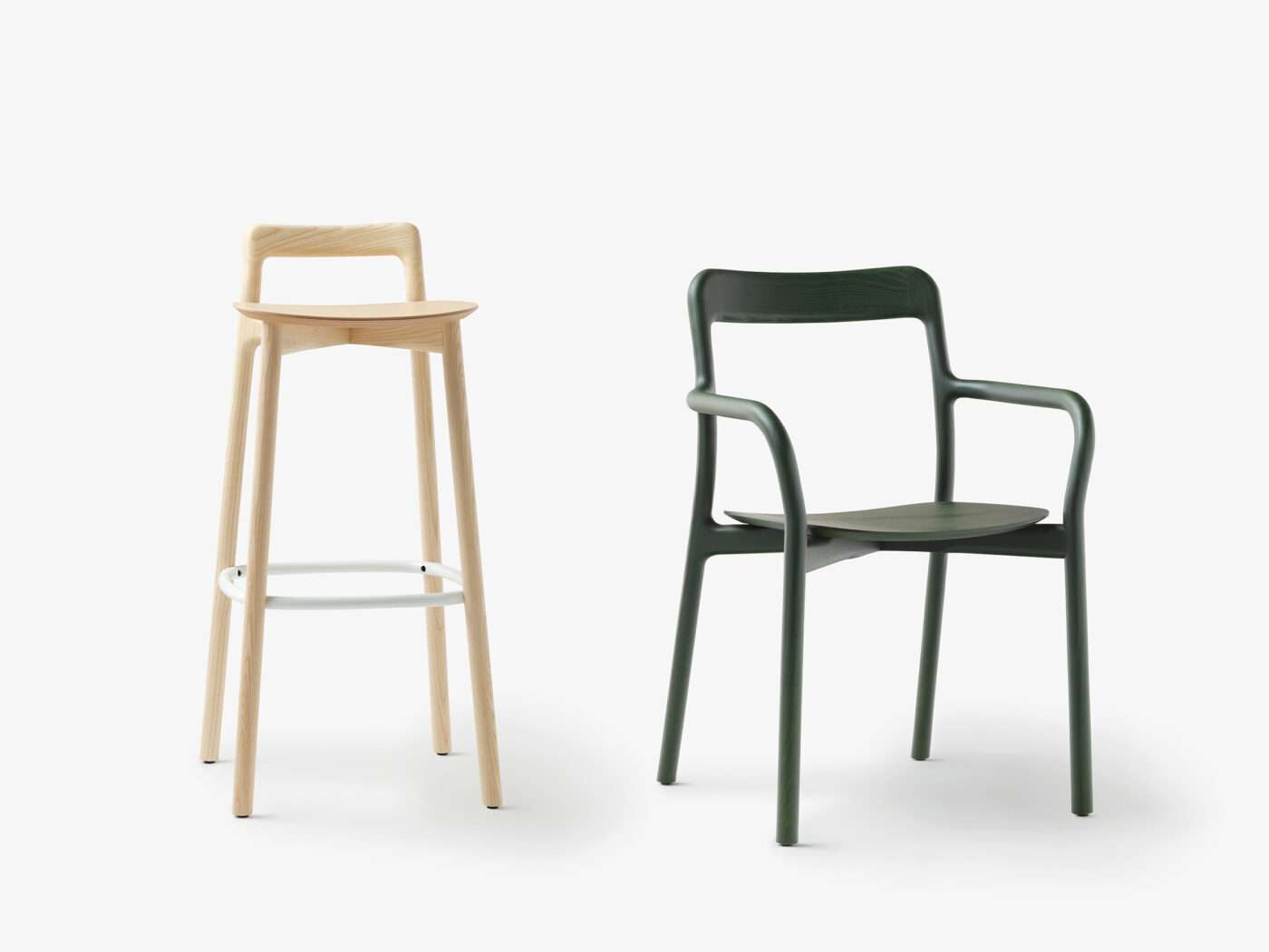 Tall wooden bar stool and a dark green armchair