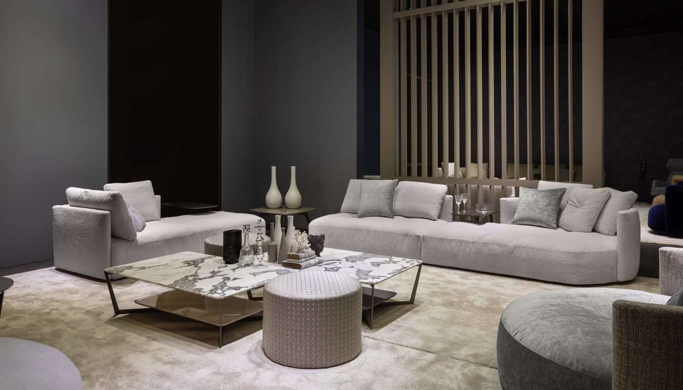 Pale sofas around round marble-topped tables in a room with timber screens
