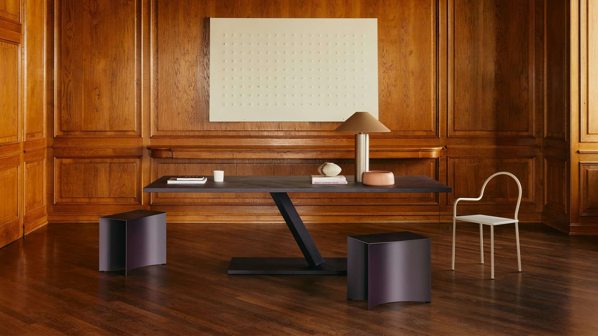 Writing desk on a single slanted leg in a walnut-panelled study