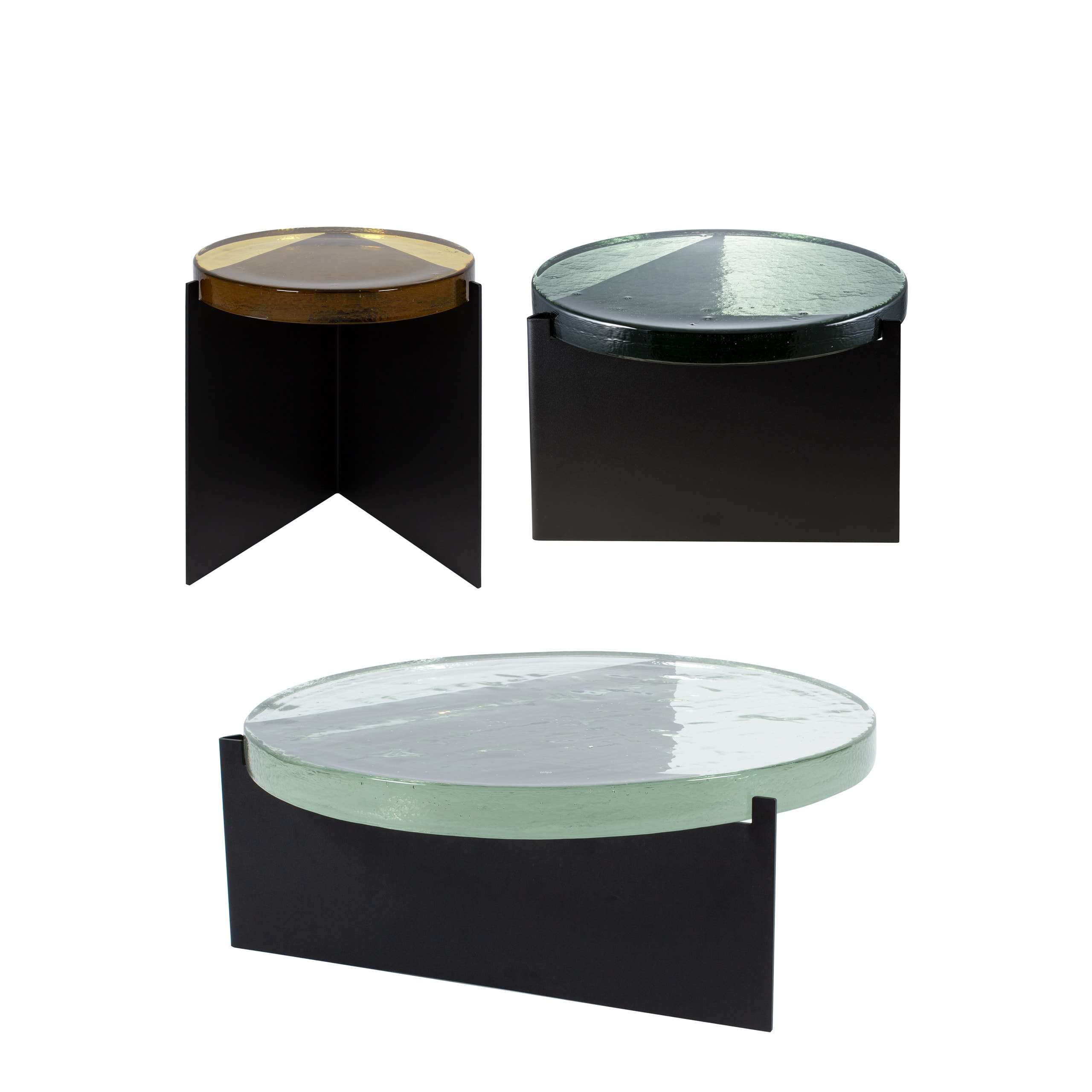 Side tables with thick glass tops on black steel bases