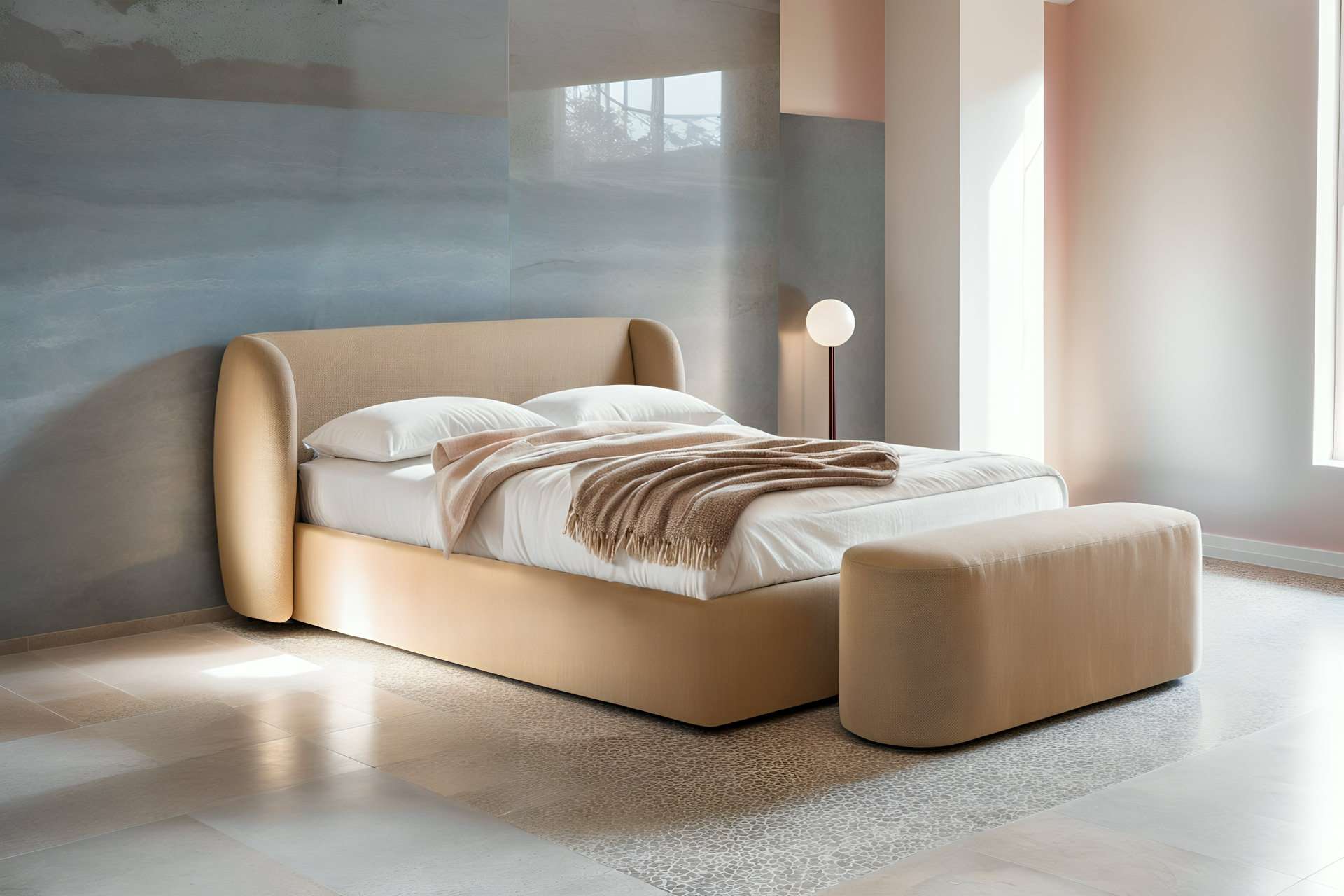 Bed with a curved upholstered headboard and a bench at its foot in a soft grey room