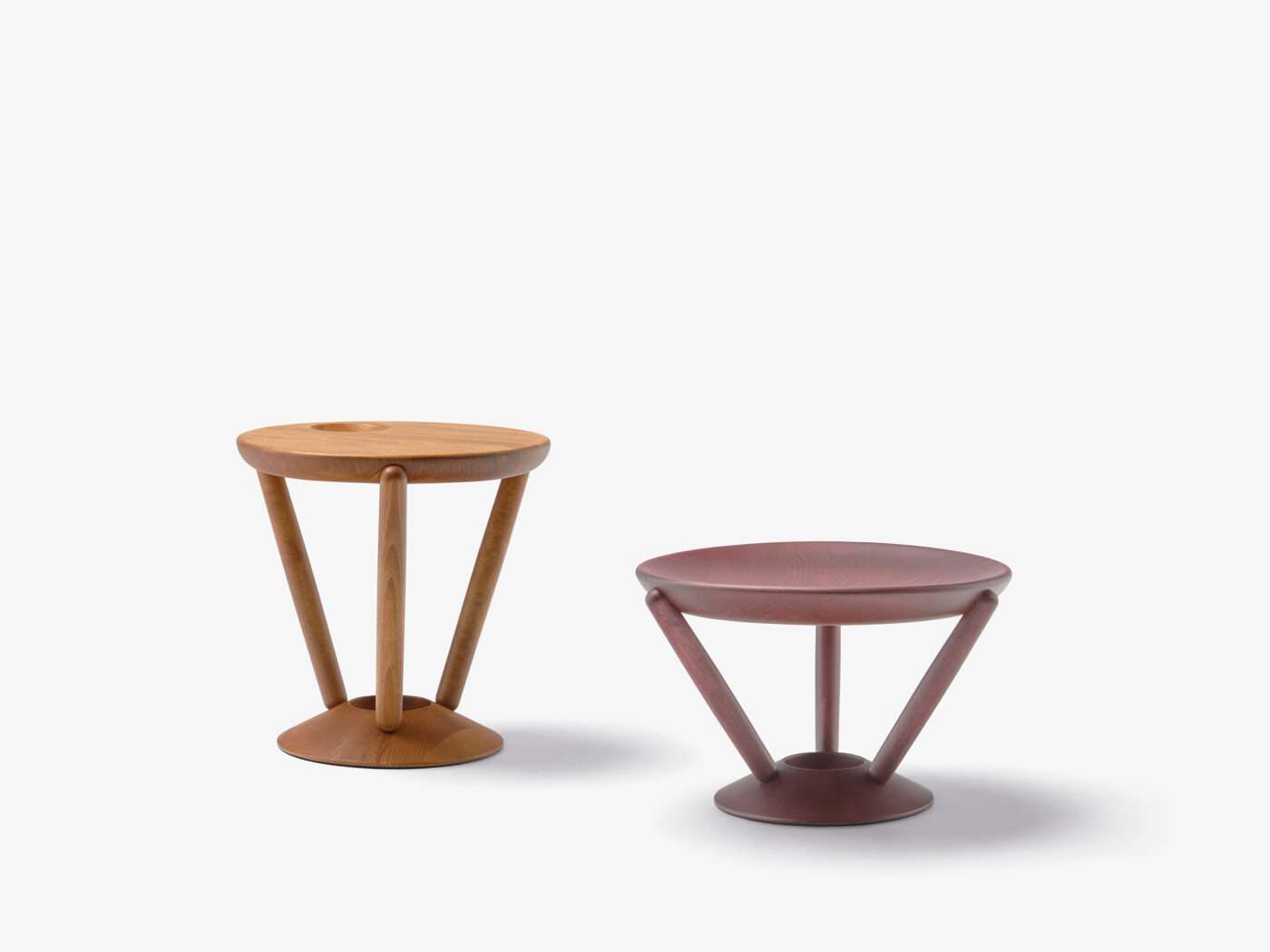 Two round side tables in oak and plum on splayed legs
