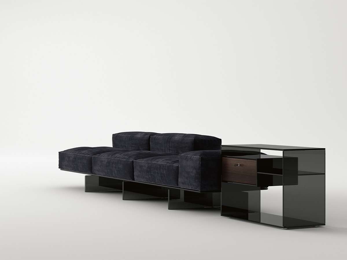 Low dark sofa beside a glass side unit