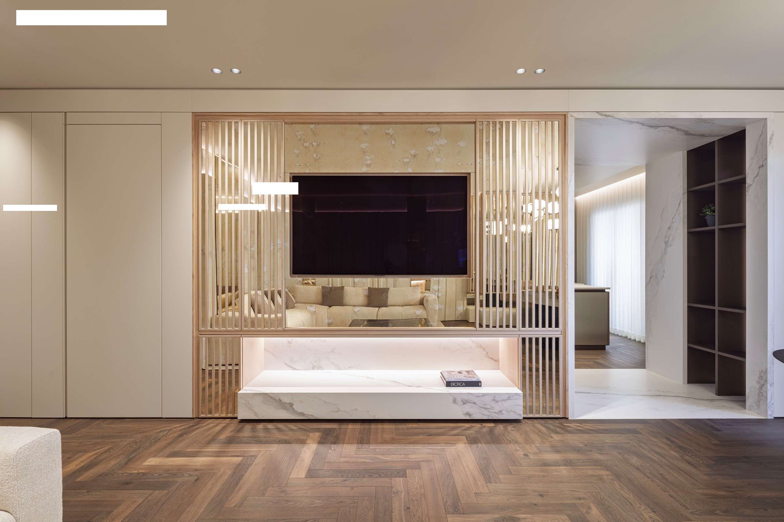 Living room with a long low console and a screen set into a slatted timber wall