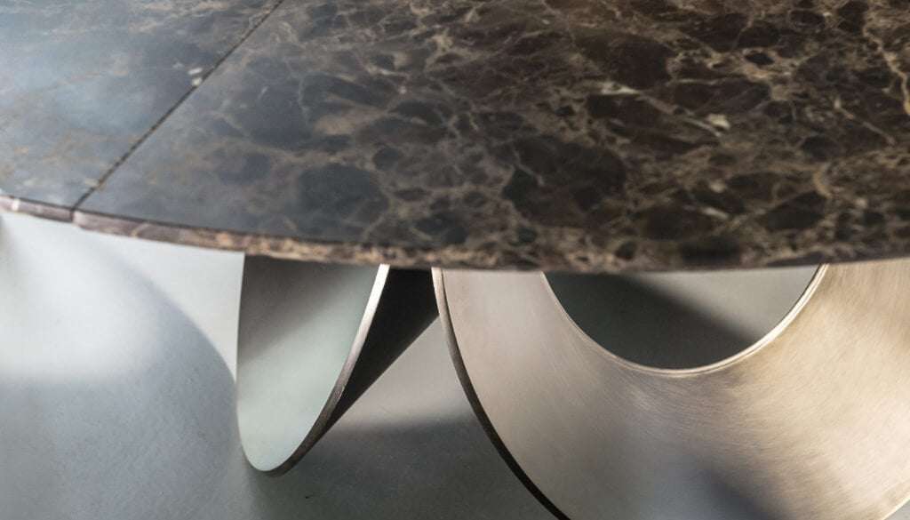 Dark marble tabletop on a curved metal base