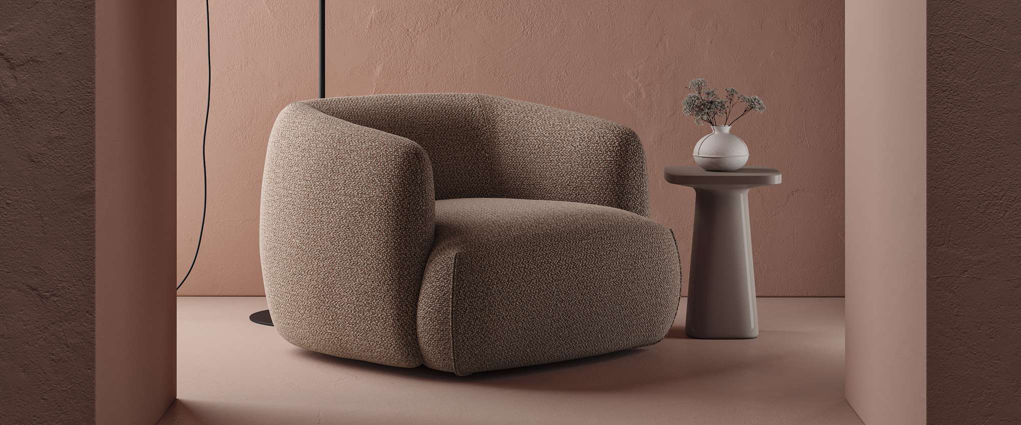 Rounded armchair in brown bouclé against a terracotta wall