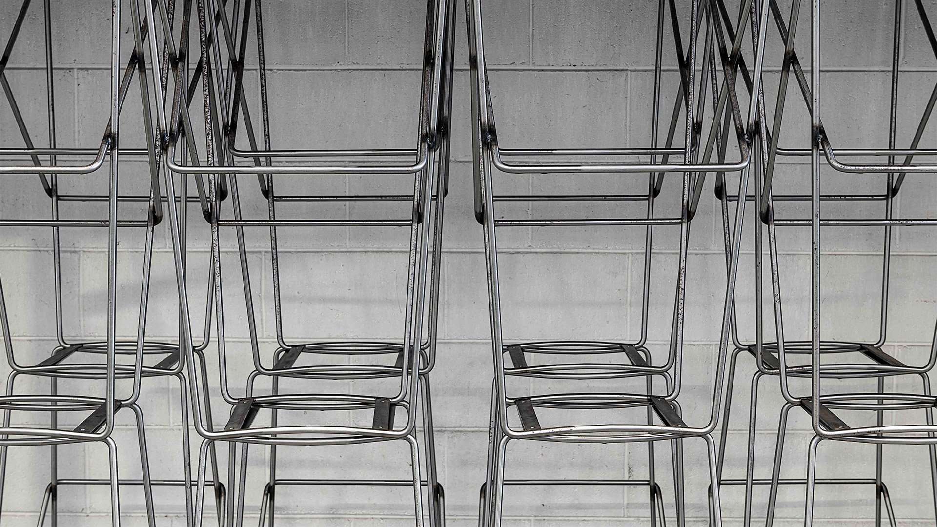 Rows of bent steel chair frames in the factory