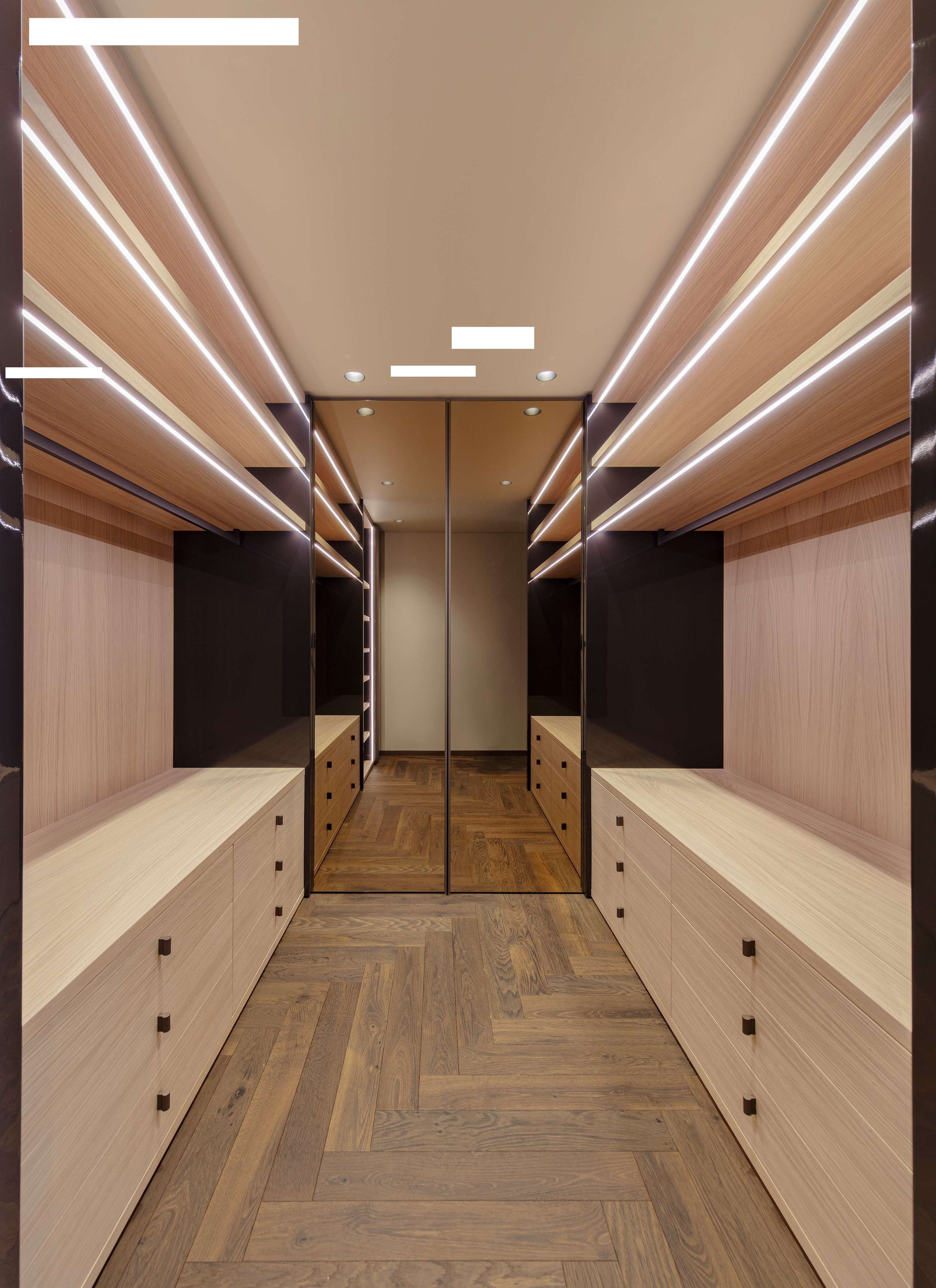 Walk-in wardrobe with lit open shelving and glass doors