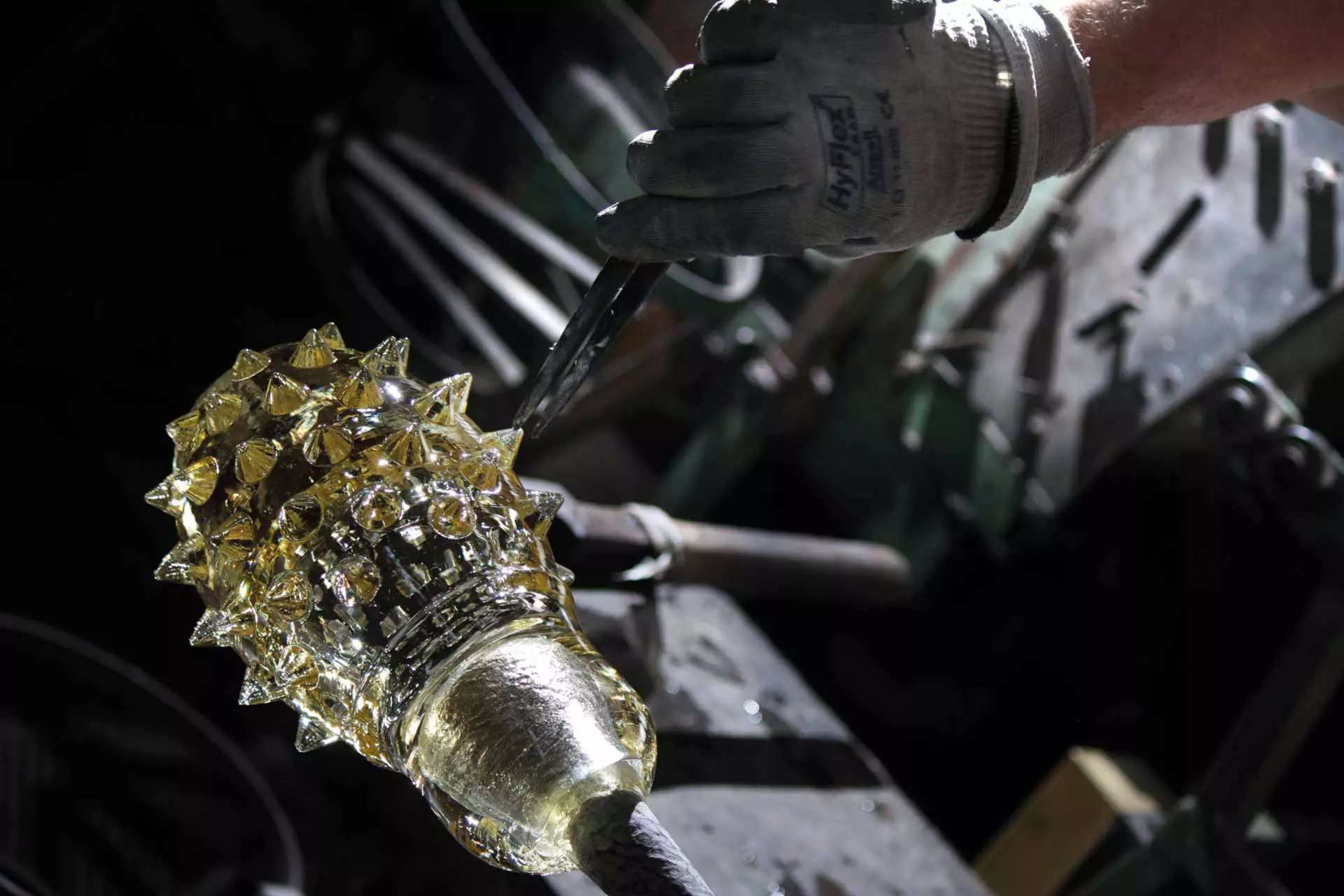 Textured glass taking shape on the end of a rod