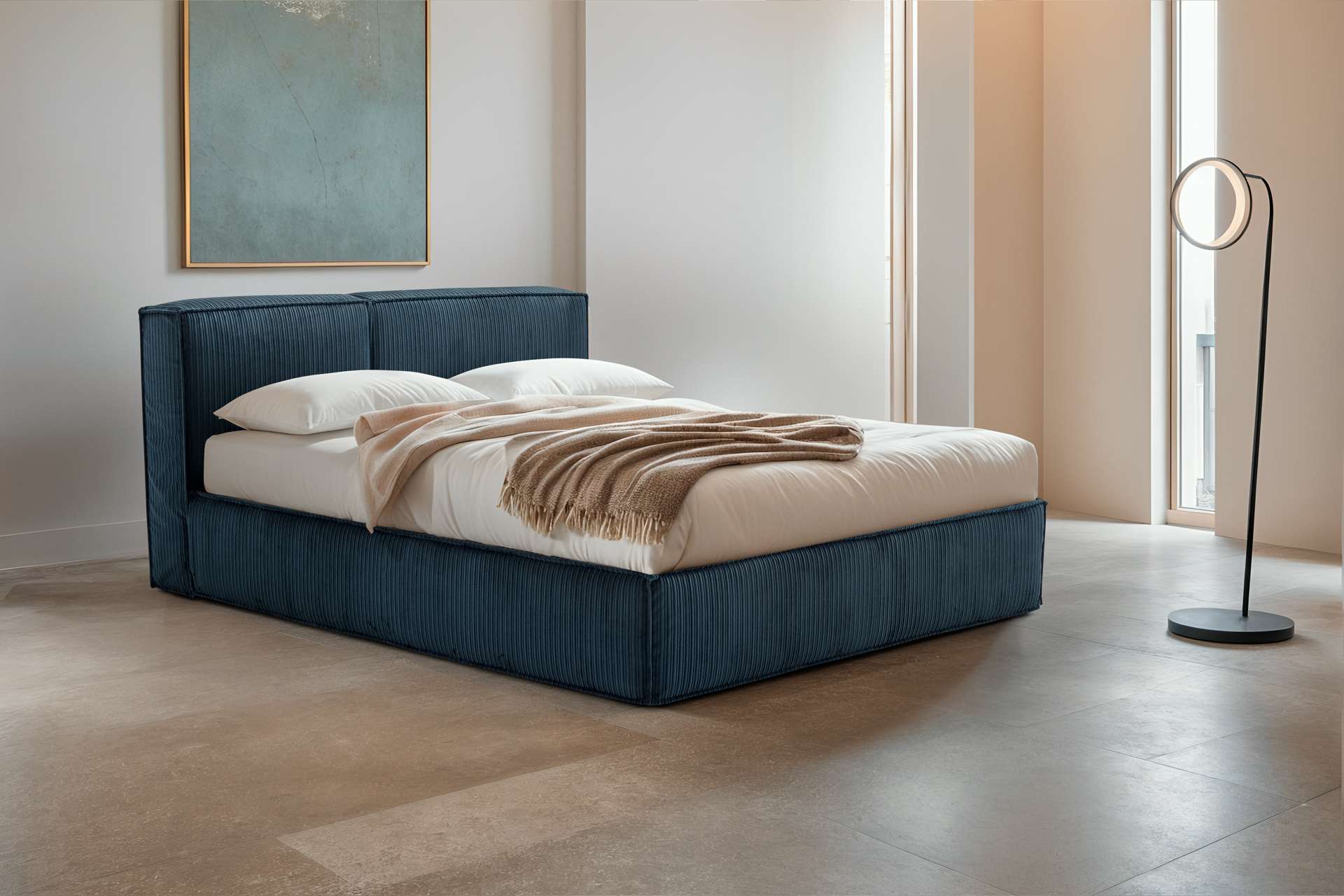 Teal upholstered bed with a beige throw in a bright room