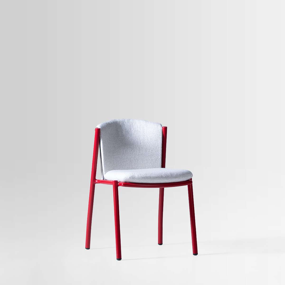 Chair with a red frame and a pale upholstered seat