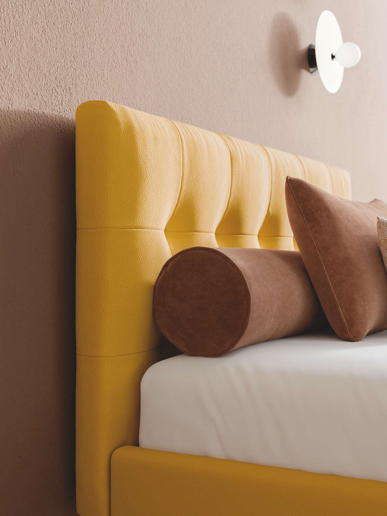 Yellow quilted headboard with a brown bolster cushion