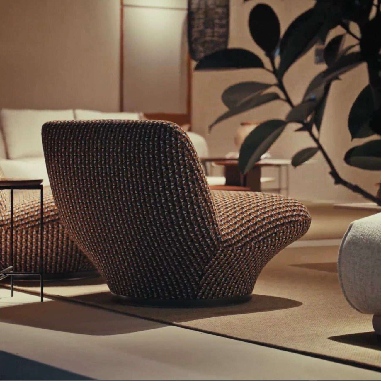 Lounge chair in woven brown cord beside a plant